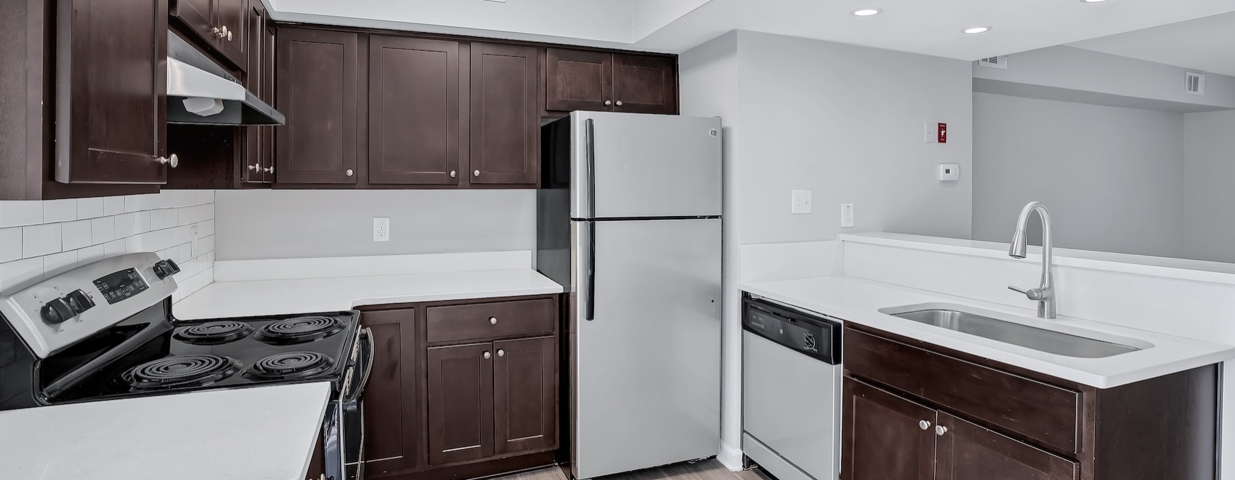 a kitchen with wooden cabinets and stainless steel appliances