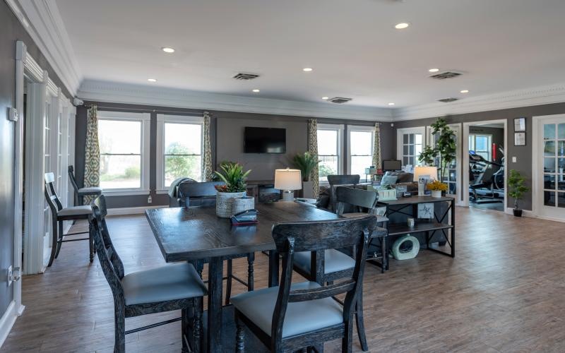 a large dining room with with seating tables and tv